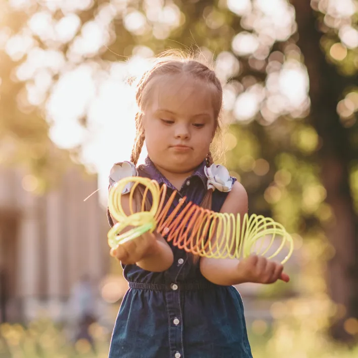 Dziewczynka z ZD bawiąca się kolorową sprężyną
